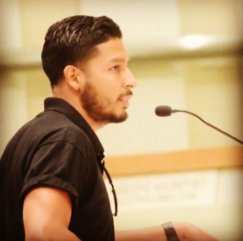 Alex speaking at a public meeting