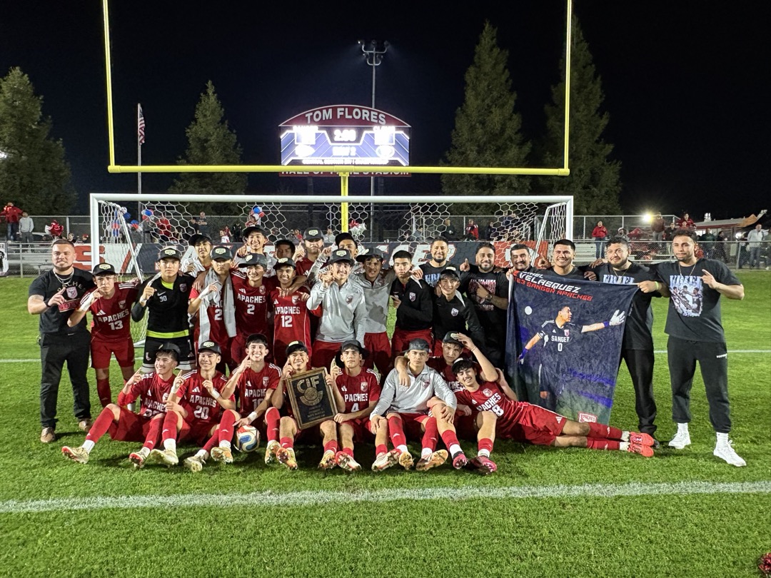 Sanger Apaches soccer team holding a CIF championship plaque